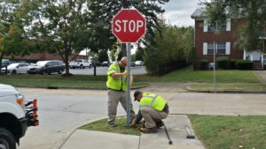 workers installing stop sign