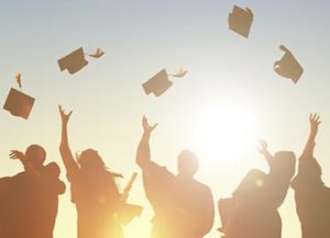 graduates throwing caps