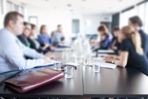 people sitting around table for business meeting